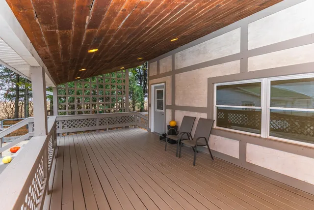 a view of a porch with wooden floor