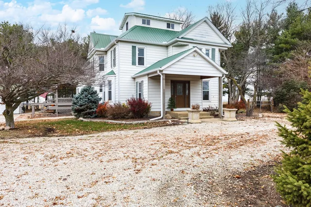 an aerial view of a house with ocean view