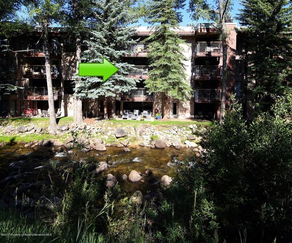 a backyard of a house with a yard and outdoor seating