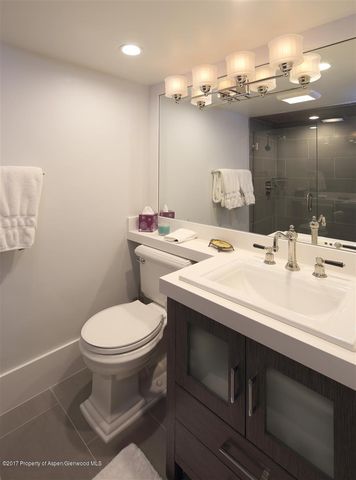 a bathroom with a sink toilet and a mirror