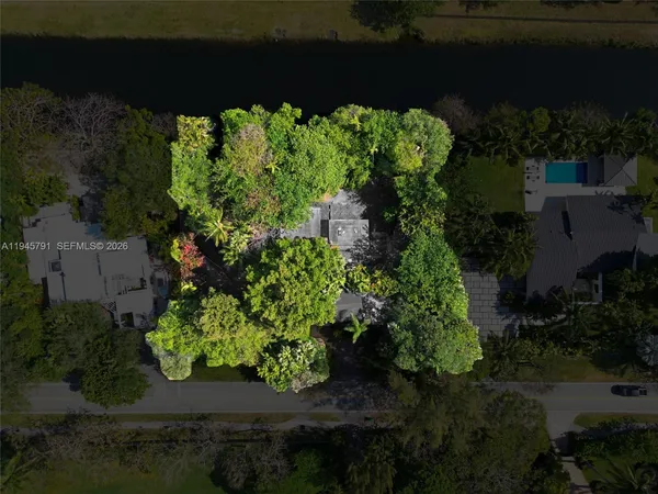 an aerial view of a house with a yard