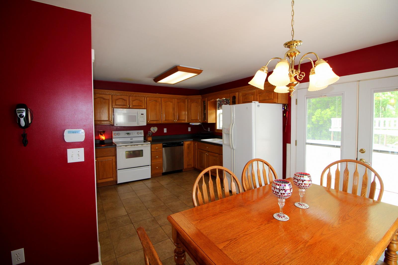 816 R B Highway Red Boiling Springs, TN 37150 - Photo 11 of 30 a kitchen with stainless steel appliances dining table and chairs