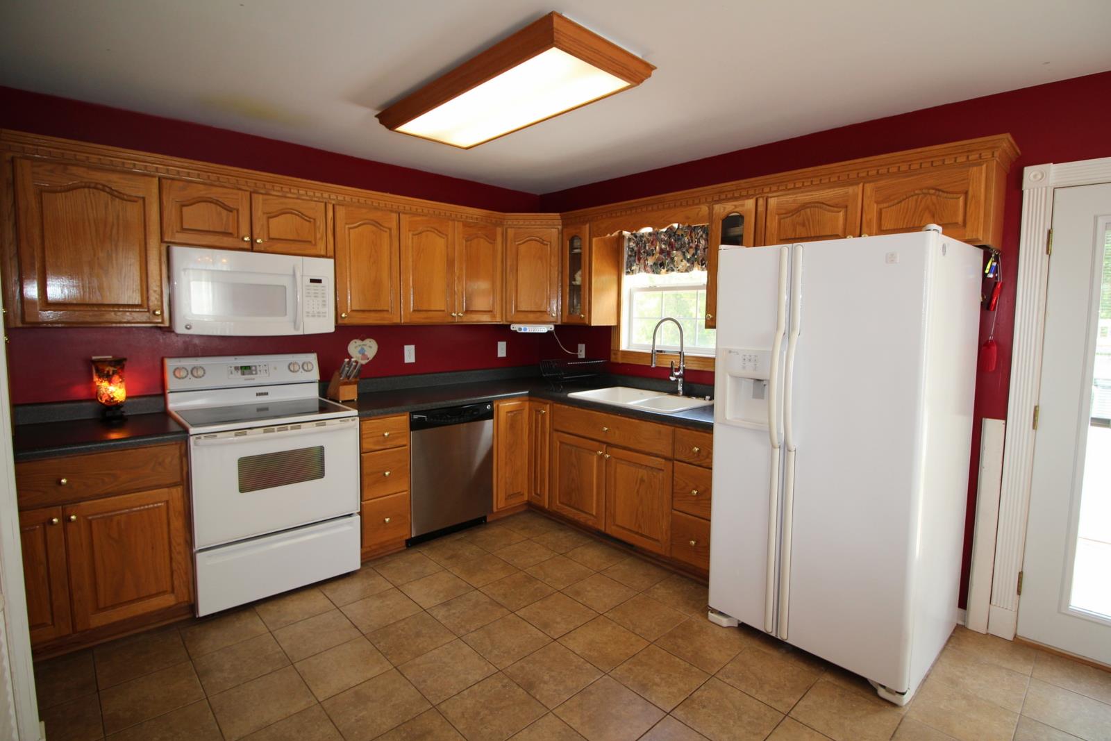 816 R B Highway Red Boiling Springs, TN 37150 - Photo 12 of 30 a kitchen with stainless steel appliances a refrigerator sink and cabinets
