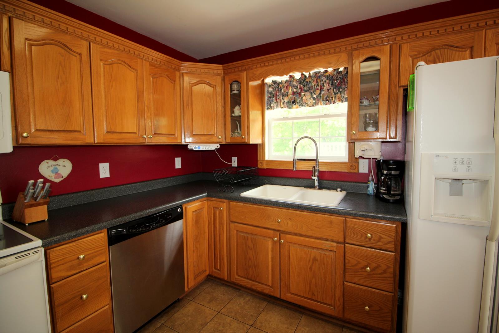 816 R B Highway Red Boiling Springs, TN 37150 - Photo 14 of 30 a kitchen with stainless steel appliances granite countertop a sink a stove and a refrigerator