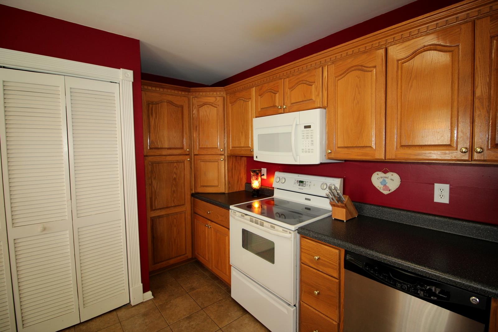816 R B Highway Red Boiling Springs, TN 37150 - Photo 15 of 30 a kitchen with stainless steel appliances granite countertop a stove and a refrigerator