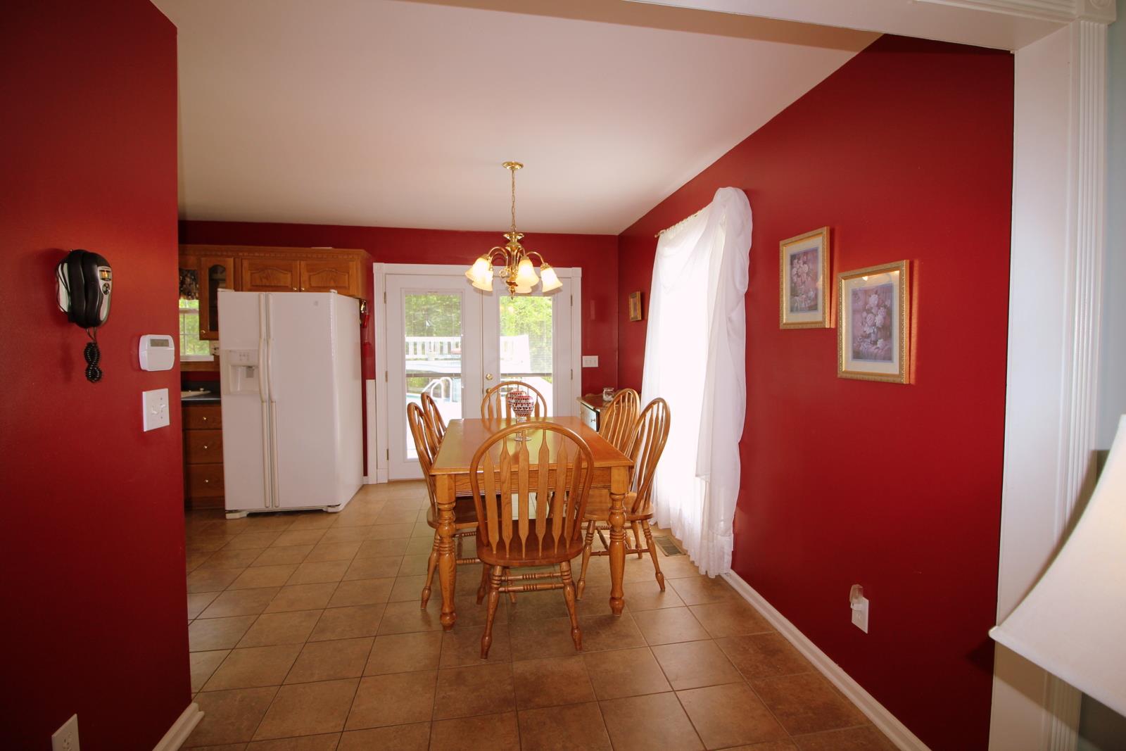 816 R B Highway Red Boiling Springs, TN 37150 - Photo 9 of 30 a view of a dining room with furniture and chandelier
