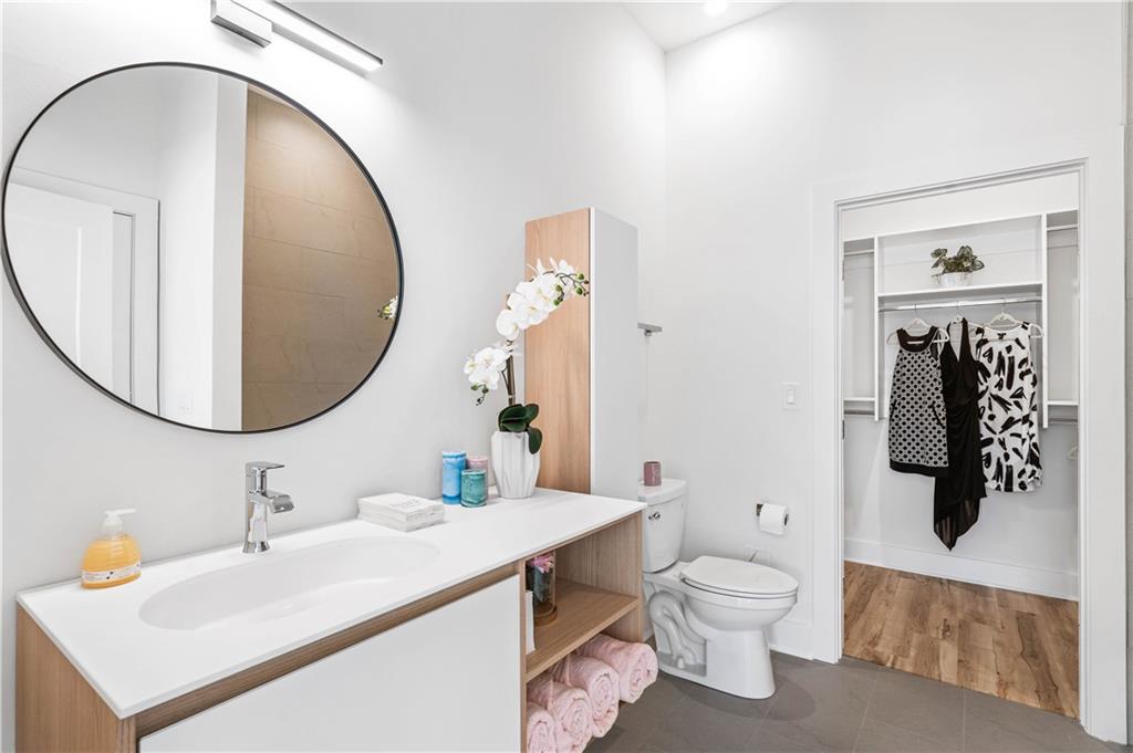 1155 Custer Avenue Southeast, Unit 202 Atlanta, GA 30316 - Photo 11 of 13 a bathroom with a sink a toilet and mirror