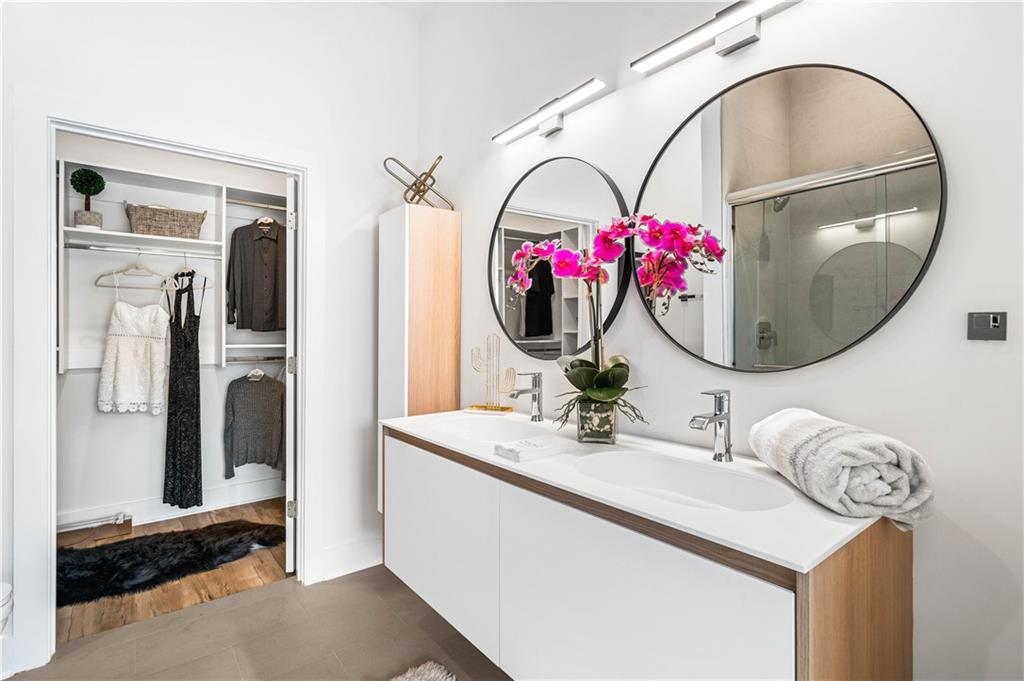 1155 Custer Avenue Southeast, Unit 202 Atlanta, GA 30316 - Photo 12 of 13 a bathroom with a sink mirror and flowers