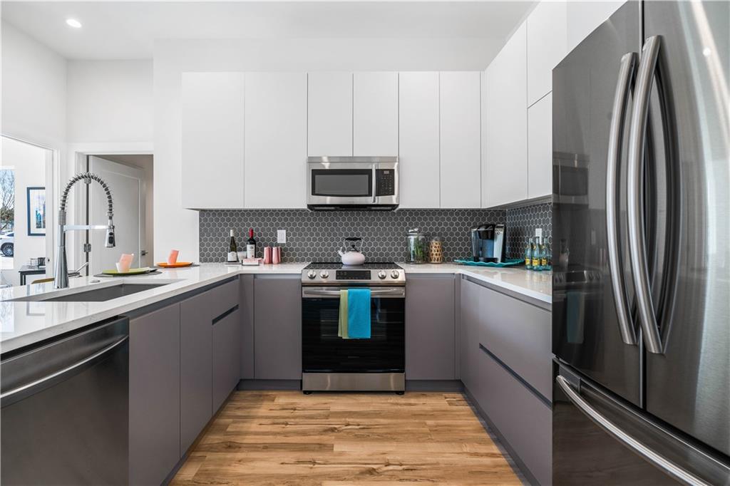 1155 Custer Avenue Southeast, Unit 202 Atlanta, GA 30316 - Photo 2 of 13 a kitchen with stainless steel appliances granite countertop a refrigerator sink and cabinets