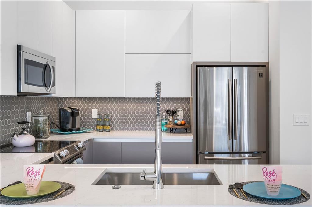 1155 Custer Avenue Southeast, Unit 202 Atlanta, GA 30316 - Photo 3 of 13 a kitchen with a sink cabinets and microwave