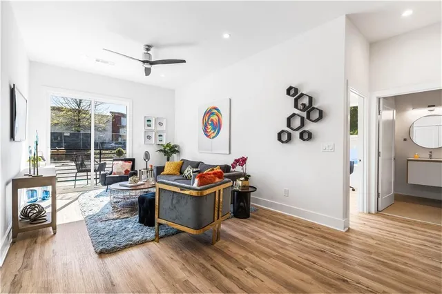 a living room with furniture and a wooden floor