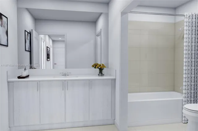a bathroom with a bathtub shower sink vanity and toilet