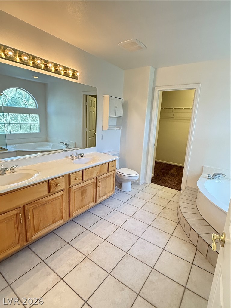 10975 Calcedonian Street Las Vegas, NV 89141 - Photo 21 of 25 This bathroom features a double vanity, a soaking tub, and tile flooring.