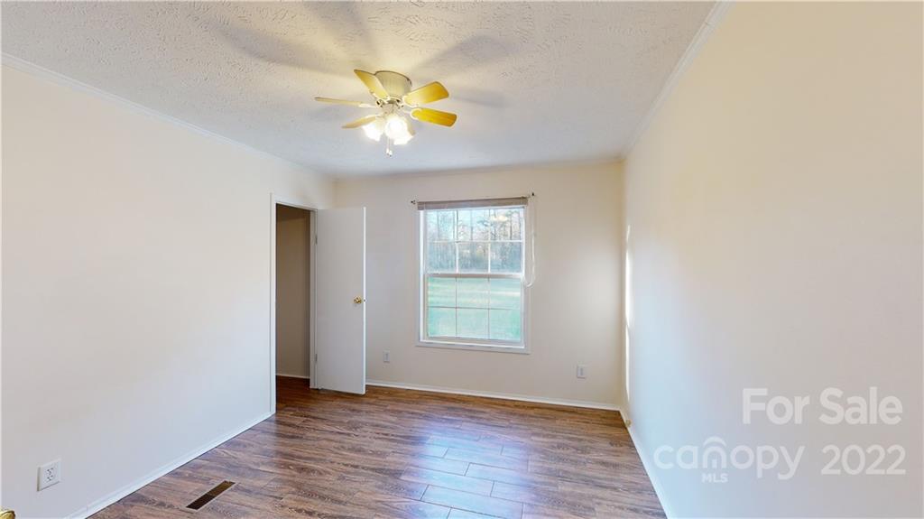 3180 Range Road Lincolnton, NC 28092 - Photo 12 of 29 an empty room with wooden floor and windows