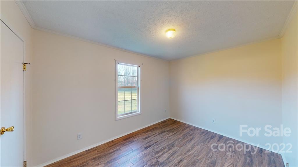 3180 Range Road Lincolnton, NC 28092 - Photo 15 of 29 an empty room with wooden floor and windows