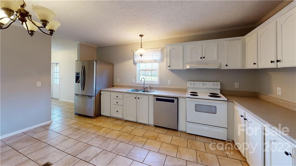 3180 Range Road Lincolnton, NC 28092 - Photo 22 of 29 a kitchen with stainless steel appliances granite countertop a sink a stove a refrigerator and cabinets