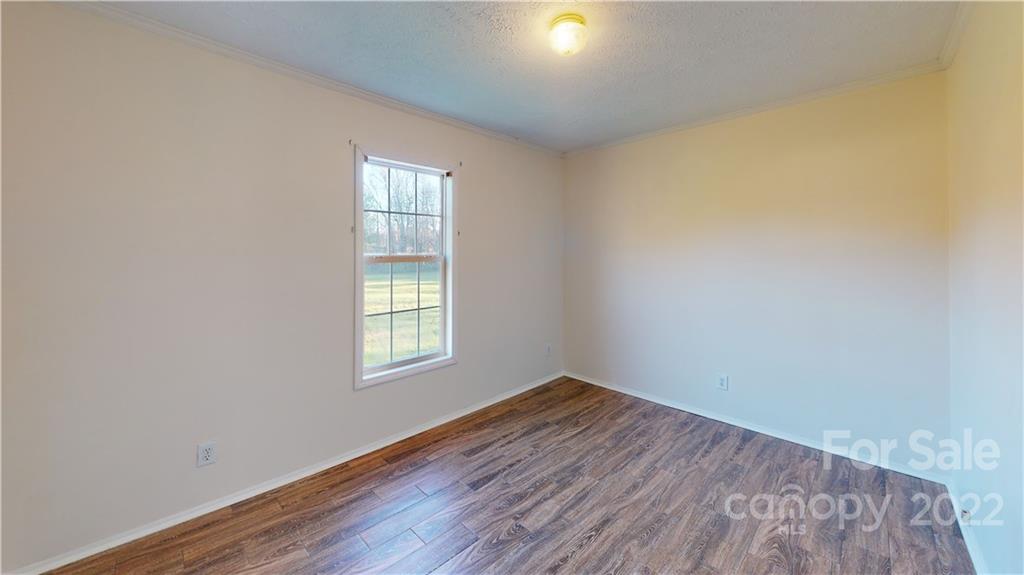 3180 Range Road Lincolnton, NC 28092 - Photo 28 of 29 an empty room with wooden floor and windows