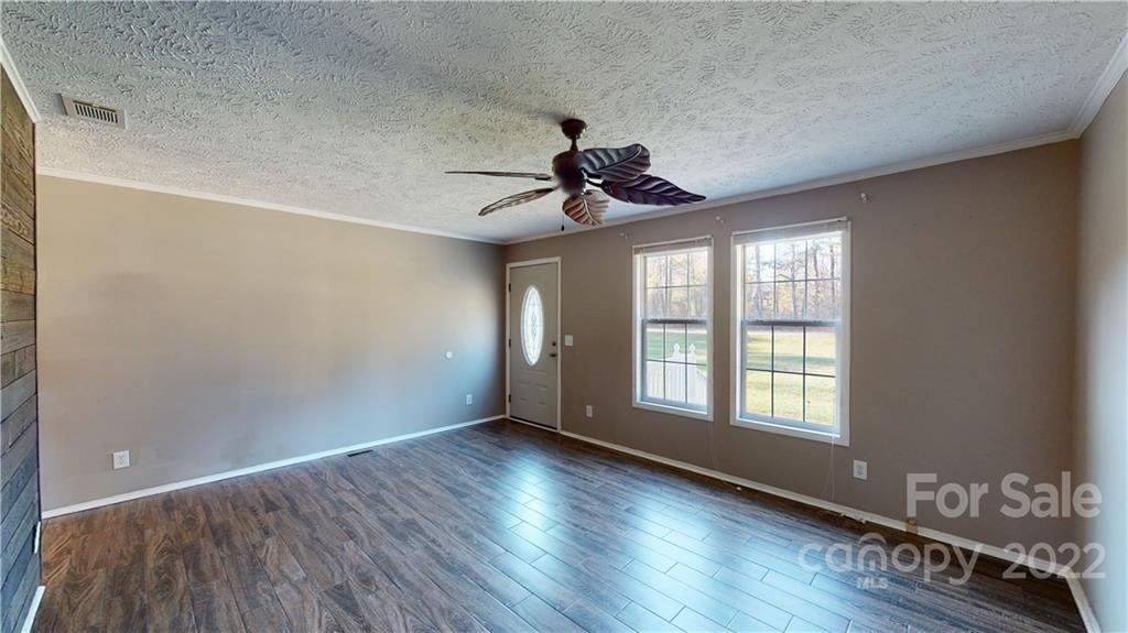 3180 Range Road Lincolnton, NC 28092 - Photo 4 of 29 a view of an empty room with a window and wooden floor