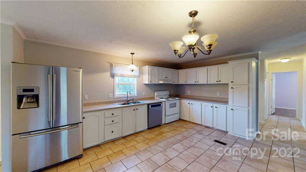 3180 Range Road Lincolnton, NC 28092 - Photo 9 of 29 a kitchen with stainless steel appliances granite countertop a refrigerator a sink dishwasher a stove and white cabinets
