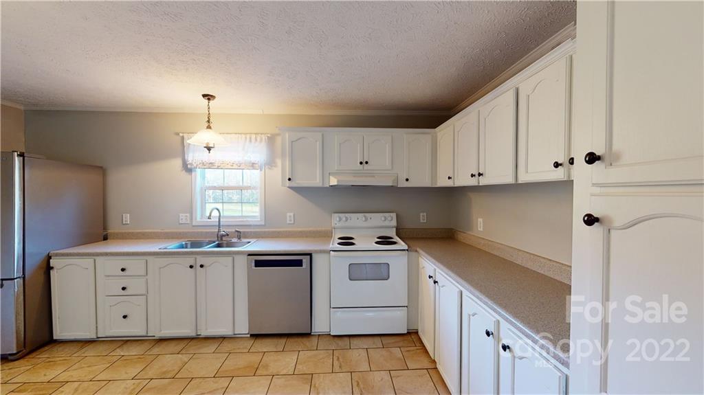 3180 Range Road Lincolnton, NC 28092 - Photo 10 of 29 a kitchen with a sink stove and cabinets