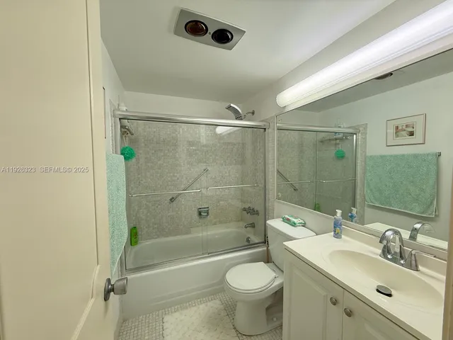 a bathroom with a sink mirror toilet and bathtub