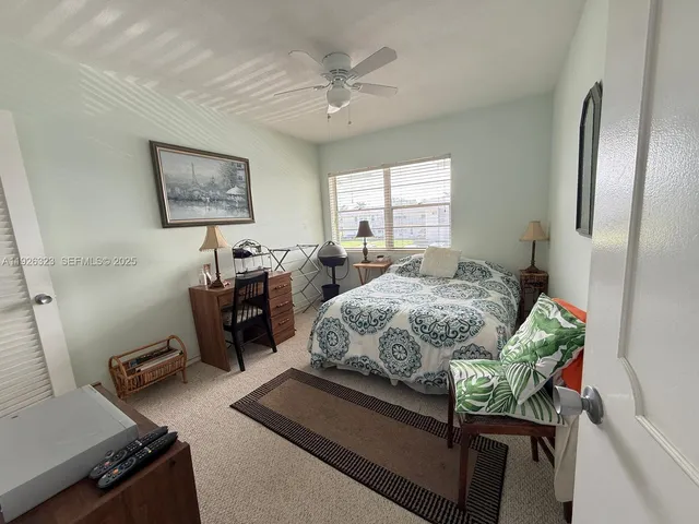 a spacious bedroom with a bed and a chandelier