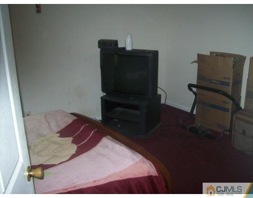 74 Ashley Road Edison, NJ 08817 - Photo 8 of 10 a bedroom with a bed and furniture