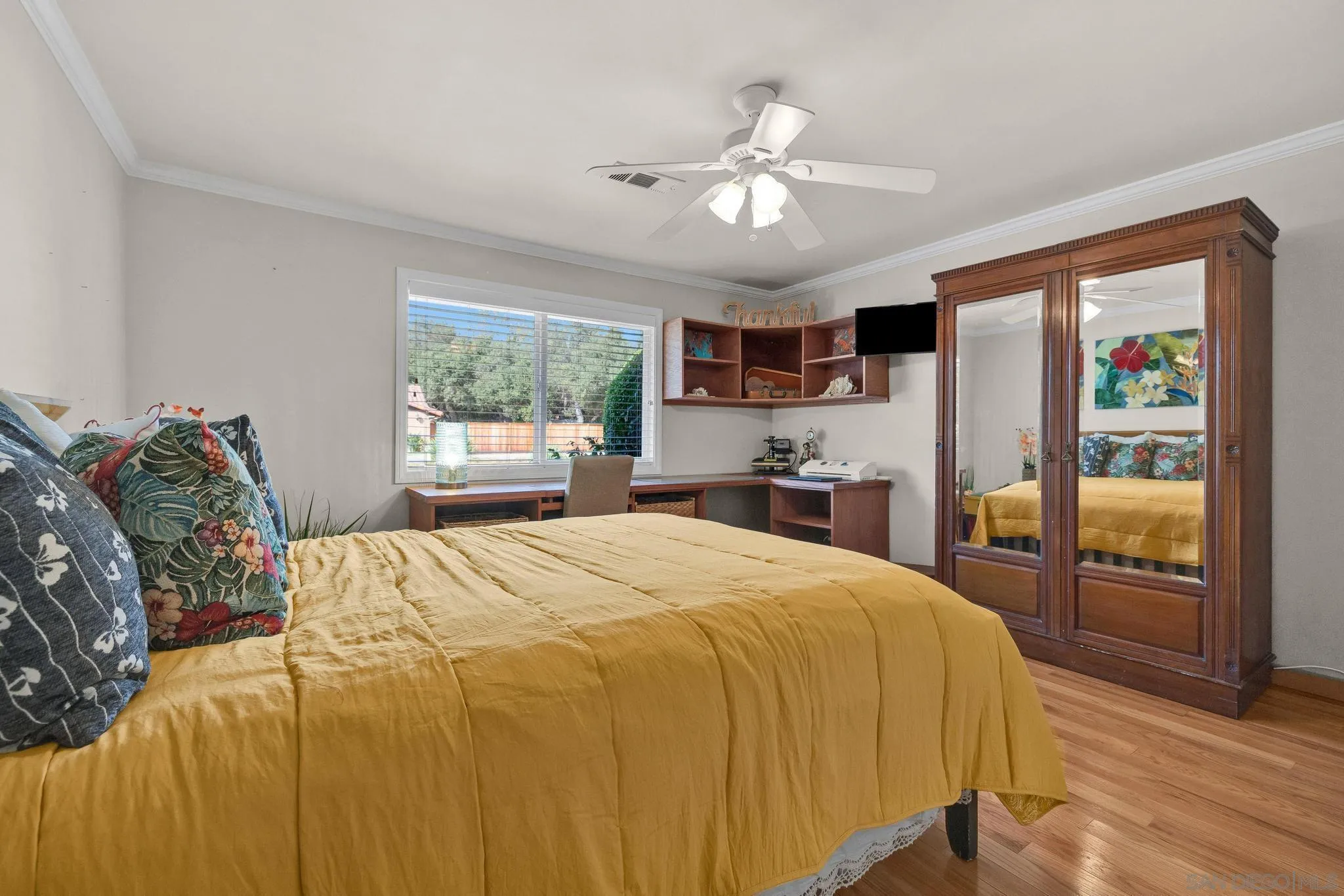 1695 Calmin Way Fallbrook, CA 92028 - Photo 23 of 44 a spacious bedroom with a bed and dresser with wooden floor