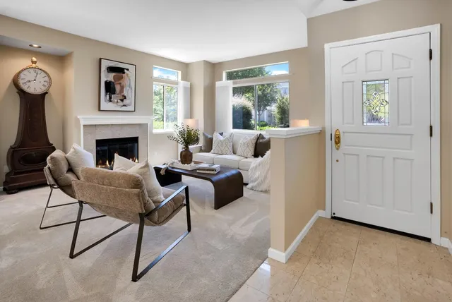 a living room with furniture and a fireplace