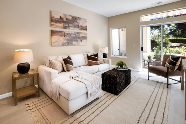 a bedroom with a bed and a large window