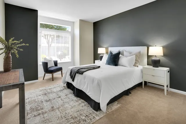 a bedroom with a bed lamps and window