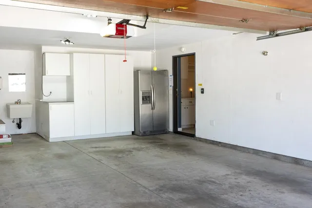 a backyard of a house with table and chairs