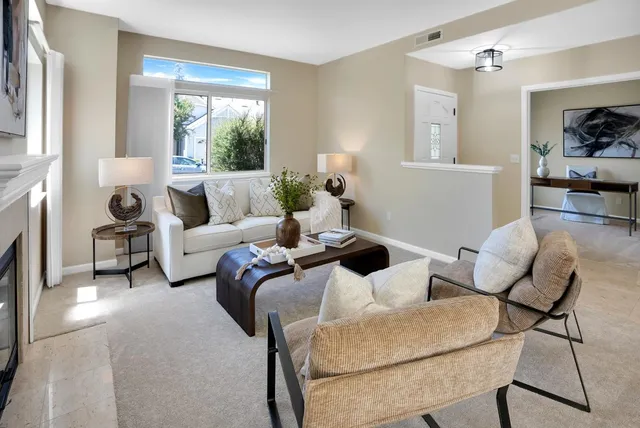a living room with furniture and a fireplace