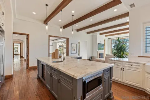 a dining room with furniture and a potted plant