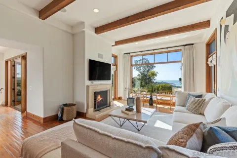 a kitchen with a sink and living room view