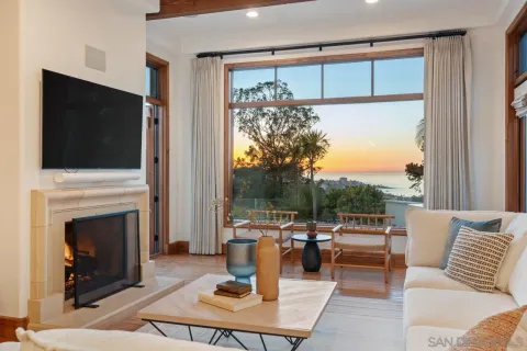 a living room with furniture a flat screen tv and a fireplace