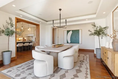 a kitchen with a stove and a wooden floor