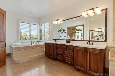 a bathroom with a granite countertop sink mirror toilet and bathtub