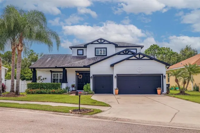 a front view of a house with a yard and garage