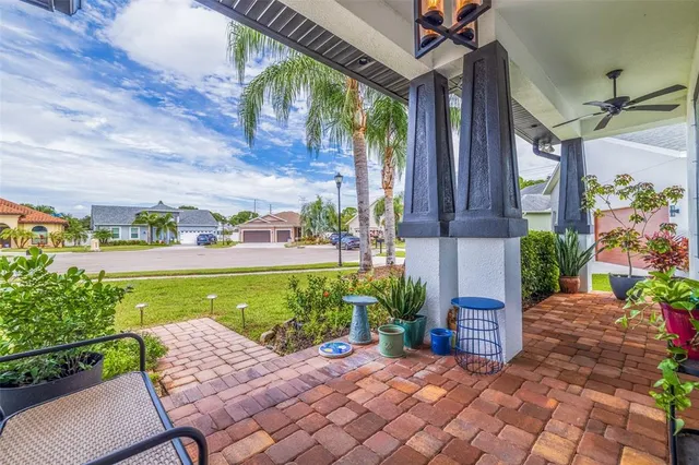 a view of a chairs and table in patio with a lake view