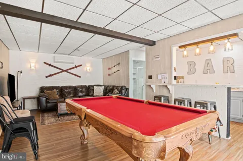 a room with pool table and windows