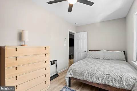 a bedroom with a bed and cabinet