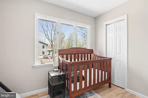 a view of a bedroom with furniture window and wooden floor