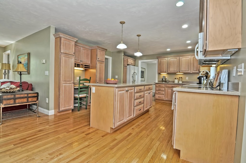 36 Proctor Road Townsend, MA 01469 - Photo 11 of 29 a kitchen with stainless steel appliances granite countertop a sink a stove a refrigerator and white cabinets with wooden floor