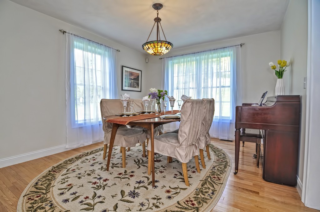 36 Proctor Road Townsend, MA 01469 - Photo 15 of 29 a dining room with furniture a rug and a chandelier