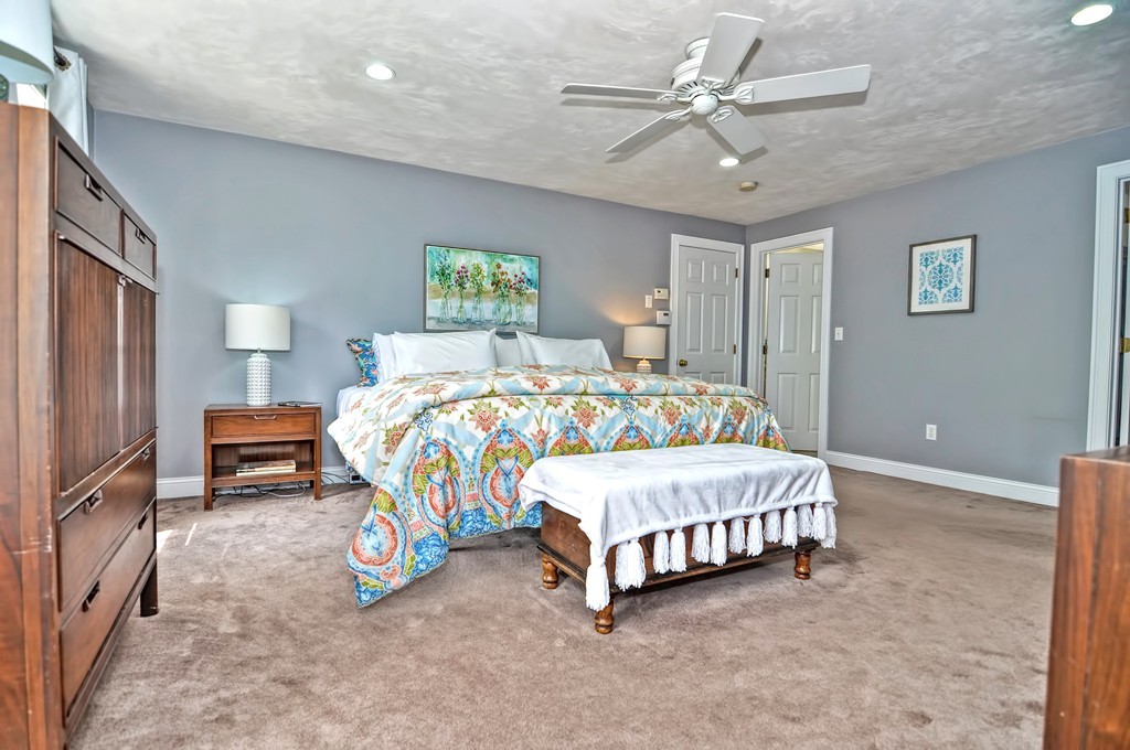 36 Proctor Road Townsend, MA 01469 - Photo 19 of 29 a bedroom with a bed and a chandelier