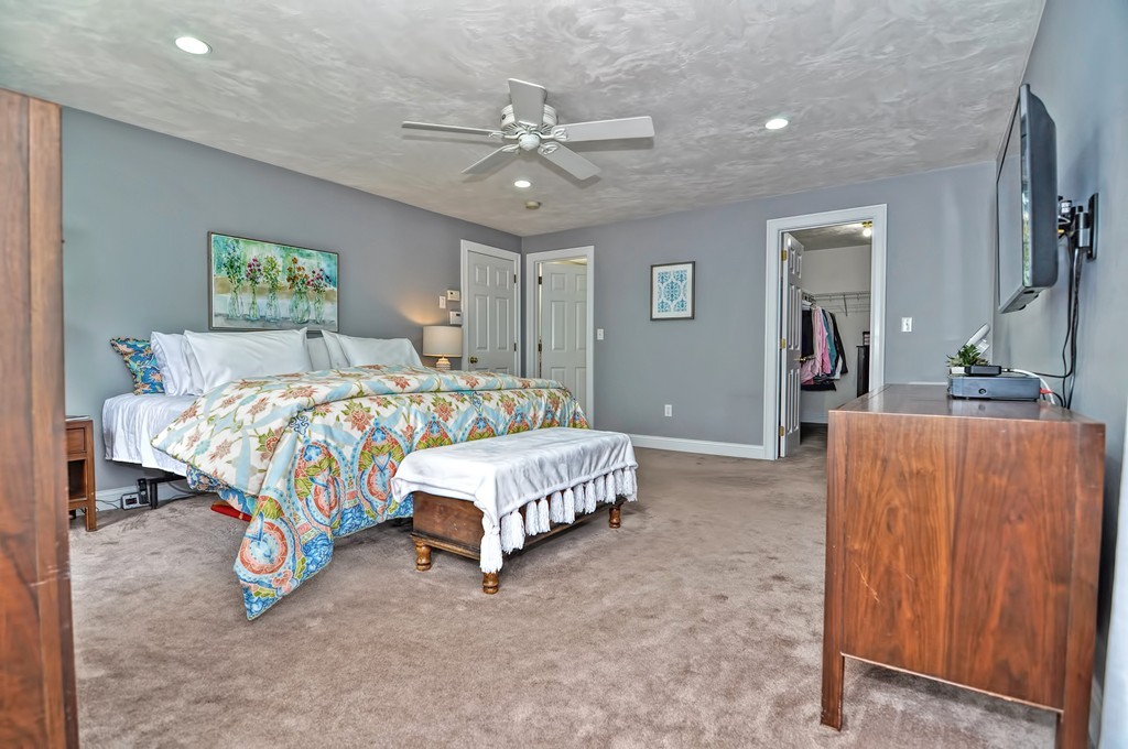36 Proctor Road Townsend, MA 01469 - Photo 20 of 29 a bedroom with a bed and a chandelier