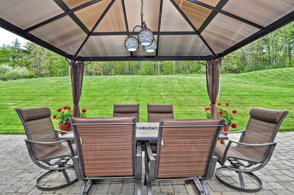 36 Proctor Road Townsend, MA 01469 - Photo 28 of 29 a view of a patio with table and chairs under an umbrella