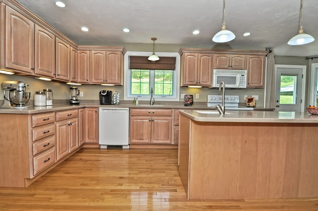 36 Proctor Road Townsend, MA 01469 - Photo 8 of 29 a kitchen with kitchen island granite countertop a sink window cabinets and stainless steel appliances
