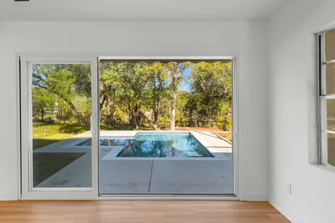 a view of a floor to ceiling window next to a yard